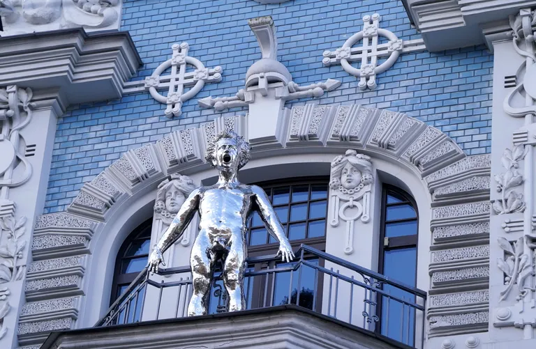Sculpture "Good Morning" by sculptor Aigars Bikše on the balcony of an Art Nouveau house on Elizabetes Street.