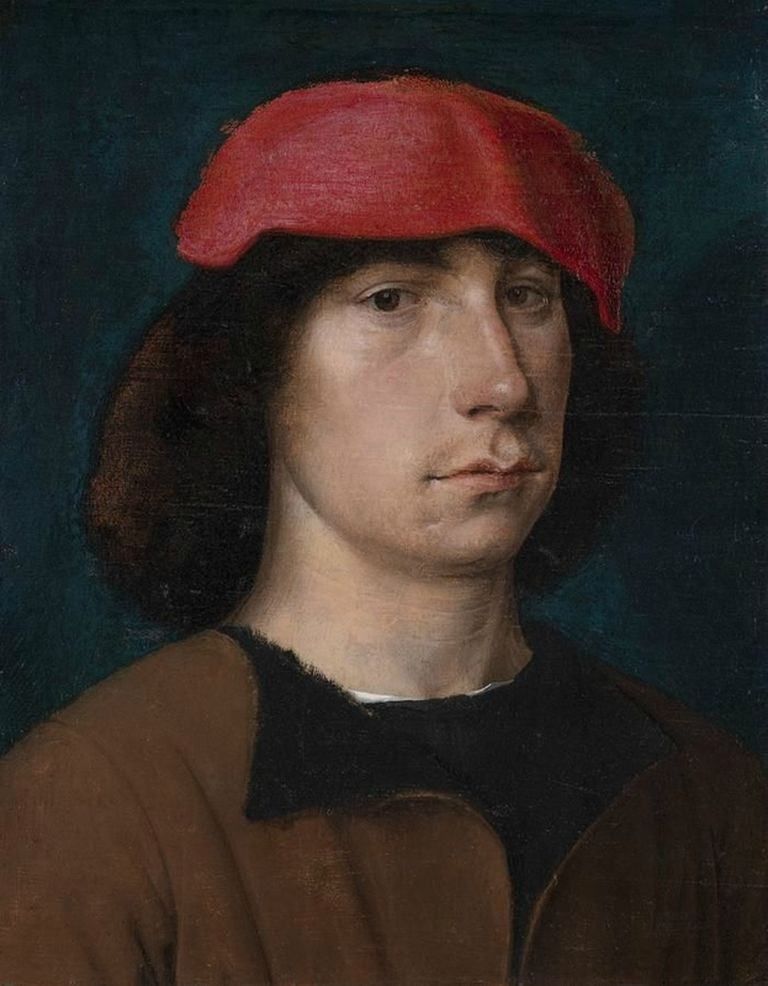 Портрет молодого человека в красной шапке.