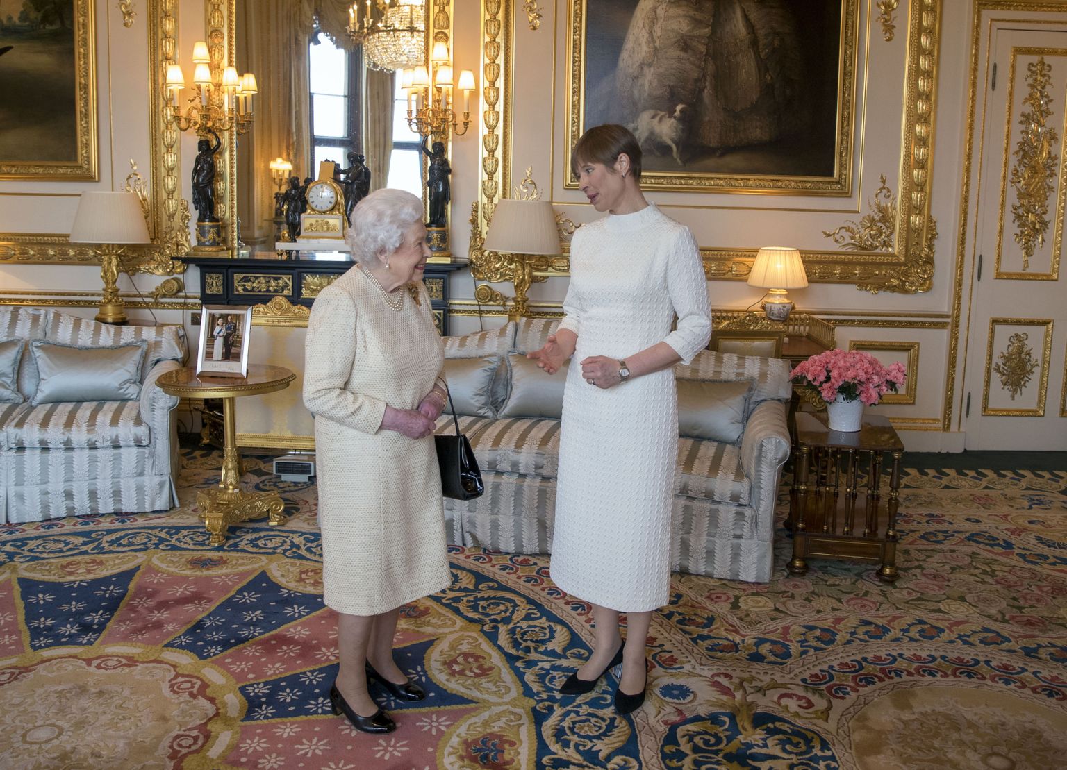 Tema Majesteet Elizabeth II ja Eesti Vabariigi president Kersti Kaljulaid. Kuninganna selja taga kapi all piilub soojapuhur.
