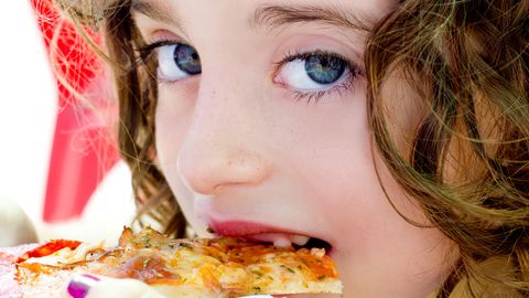 blue eyes child girl eating pizza slice blue eyes child girl eating pizza slice
