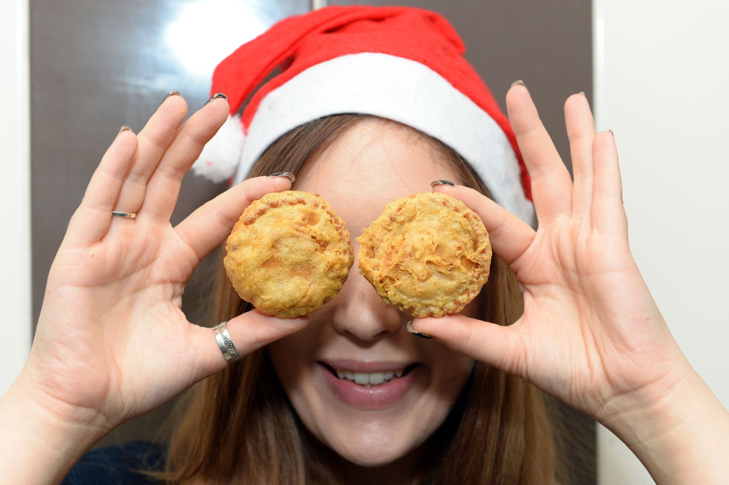 PIC FROM CATERS NEWS - (PICTURED: Hannah Crocker from birmingham with the deep fried mince pies.) - For a lighter alternative look away now - one chip shop has got two very festive offerings that have been fried to perfection. Le Codfather in Birmingham has created a deep fried mince pie and yule log, for those itching for a batter snack to eat in front of the Queens speech this year. Sam Yafaig, dips the pies in batter before popping them in the fryer for five minutes on each side, before they are ready to serve. But at an average of 280 calories a pop, before theyve been battered, those planning on sampling the extravagant delicacies might want to ask Santa Claus for a larger belt. SEE CATERS COPY.